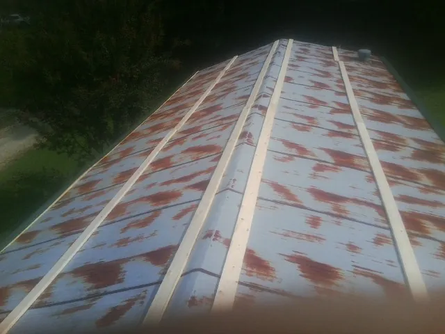 Rusted metal roof panels with new wood purlins before replacement — Storm Damage Roof Repair in Winton by Roofing Brothers